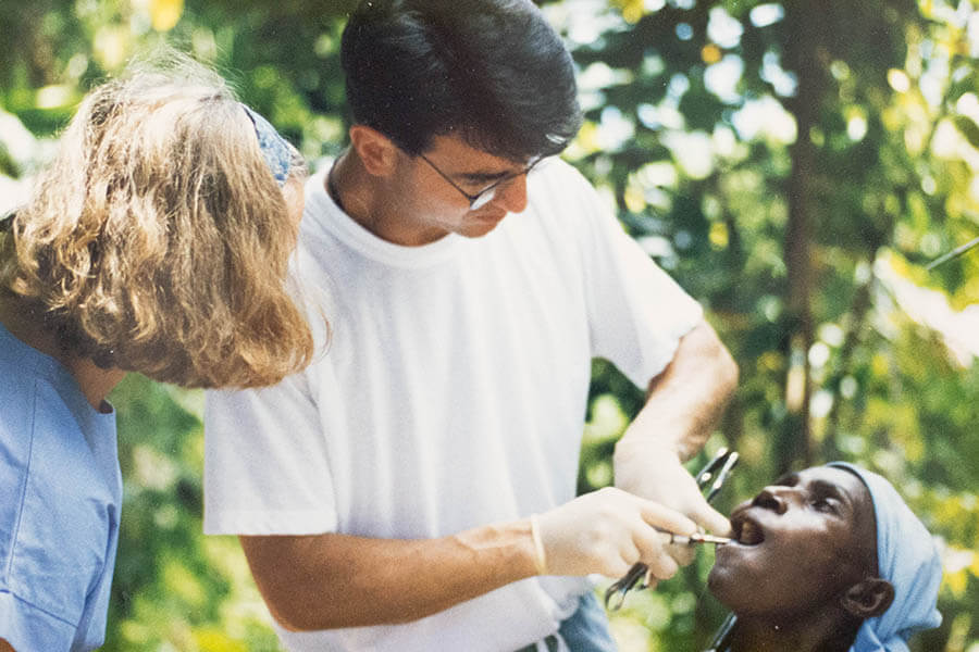 james mcdermott examining a person's teeth in haiti